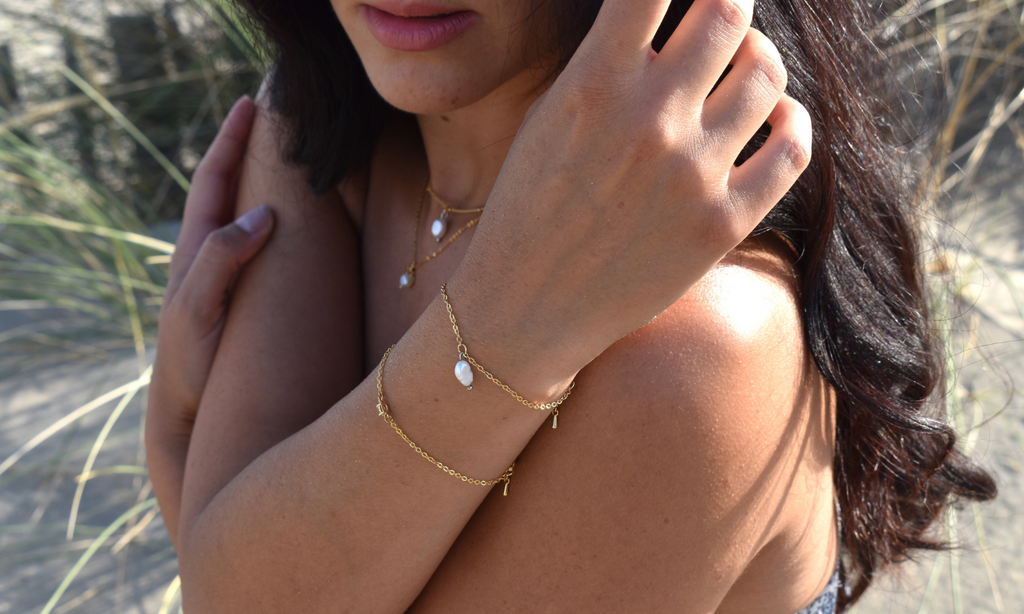 Bracelets on model at the beach - Rice pearl necklace - Gold Silver and Plated jewelry - Piper and Pearl - Dainty handmade jewelry made in Montreal - Freshwater pearls